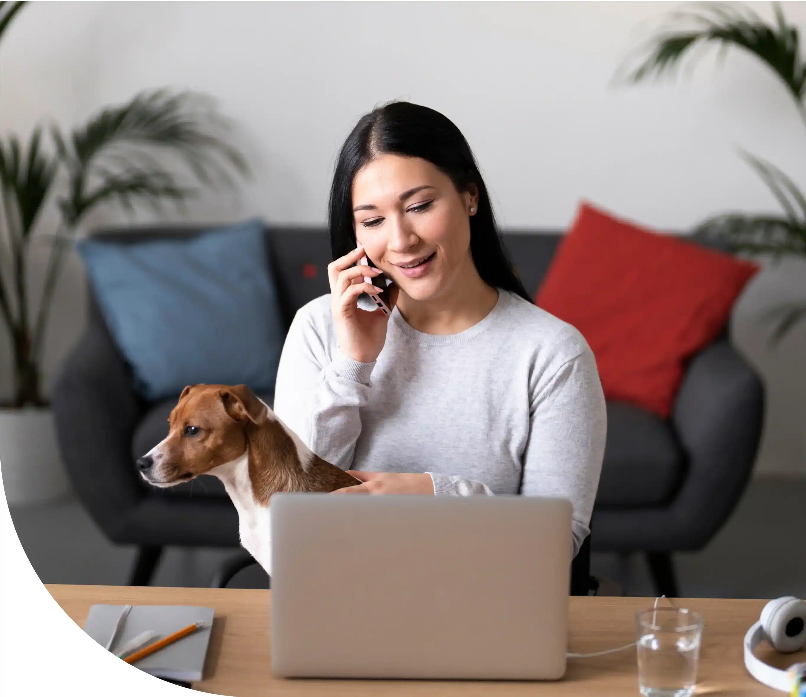 Woman working on her laptop with her dog
